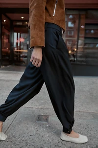 PLEATED PANTS WITH BUTTONED HEM