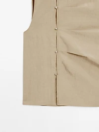 Blouse with silver button fastening on the side