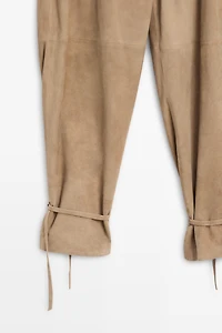 Suede leather pants with tie-detail hems