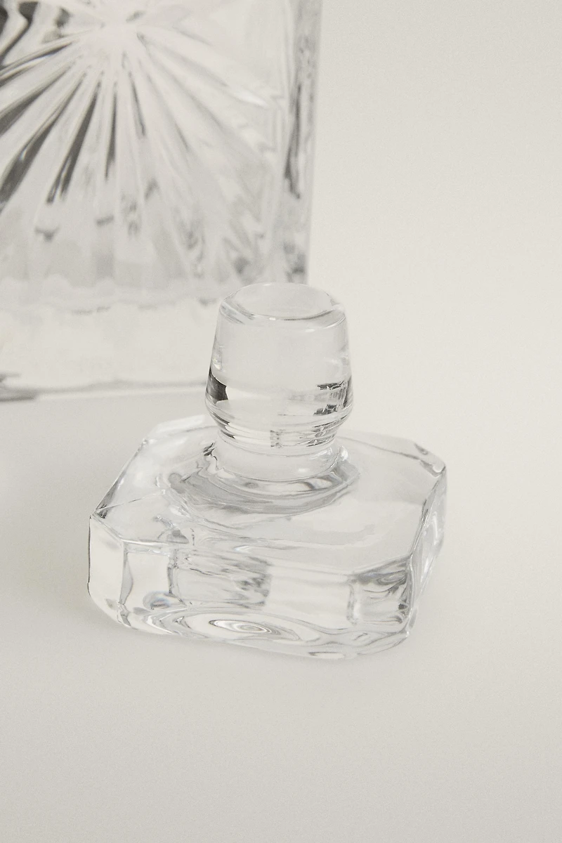 CRYSTALLINE BOTTLE WITH RAISED DESIGN