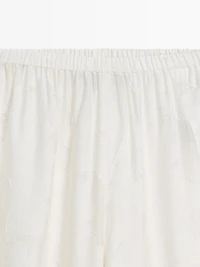 Pantalon élastique fluide détail tissu