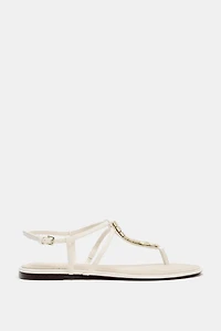 FLAT SANDALS WITH METALLIC APPLIQUES