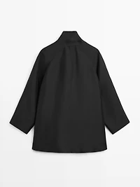 Flowing voluminous cape with button details
