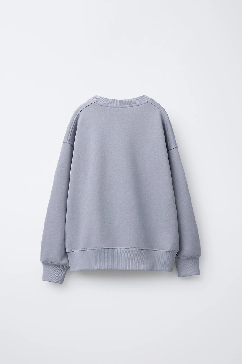 SWEAT IMPRIMÉ FLEURS ET DÉTAIL CROCHET