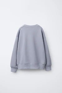 SWEAT IMPRIMÉ FLEURS ET DÉTAIL CROCHET