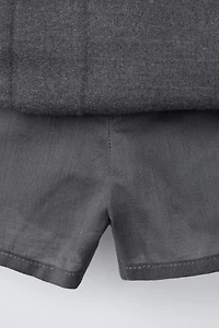 JUPE-SHORT PLIS PLATS LACETS