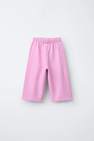 WIDE LEG INTERLOCK RAISED TEXT PANTS