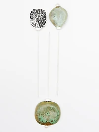 Brooch with textured ceramic piece and medallion