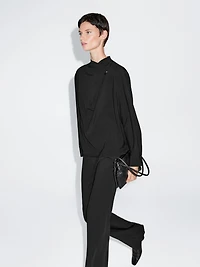 Blouse with crossover detail and button