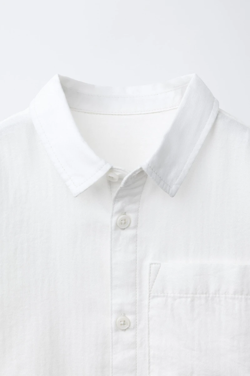 CHEMISE UNIE À POCHE