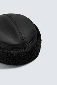 TECHNICAL CAP WITH SHEARLING EAR FLAPS