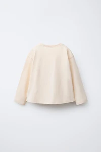 T-SHIRT AVEC INSCRIPTION FLOQUÉE