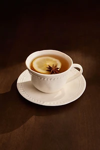 RAISED STONEWARE TEACUP AND SAUCER