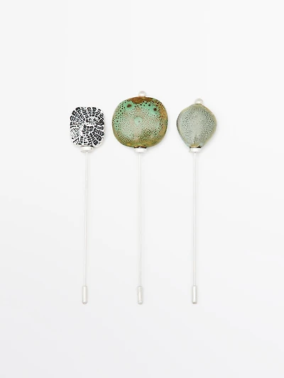 Brooch with textured ceramic piece and medallion