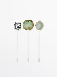 Brooch with textured ceramic piece and medallion