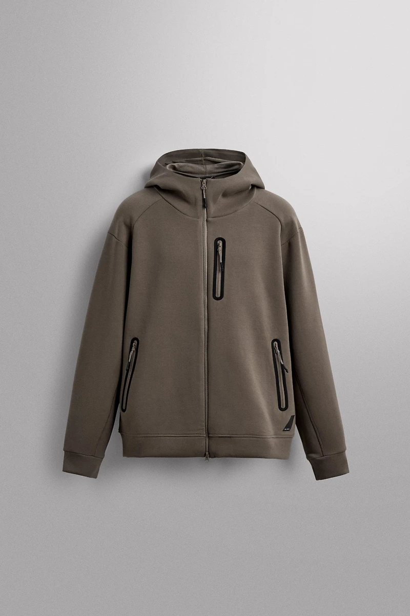 SWEAT TECHNIQUE ZIPPÉ À CAPUCHE