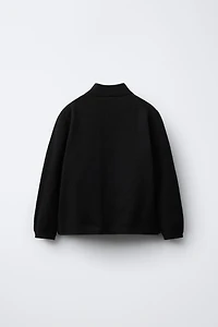 PULL EN MAILLE À COL CHEMINÉE
