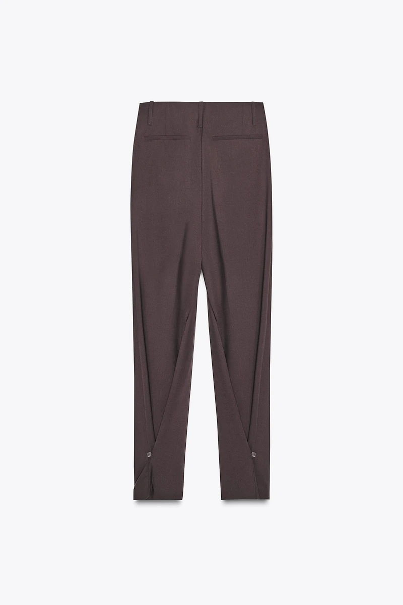 PLEATED PANTS WITH BUTTON HEM