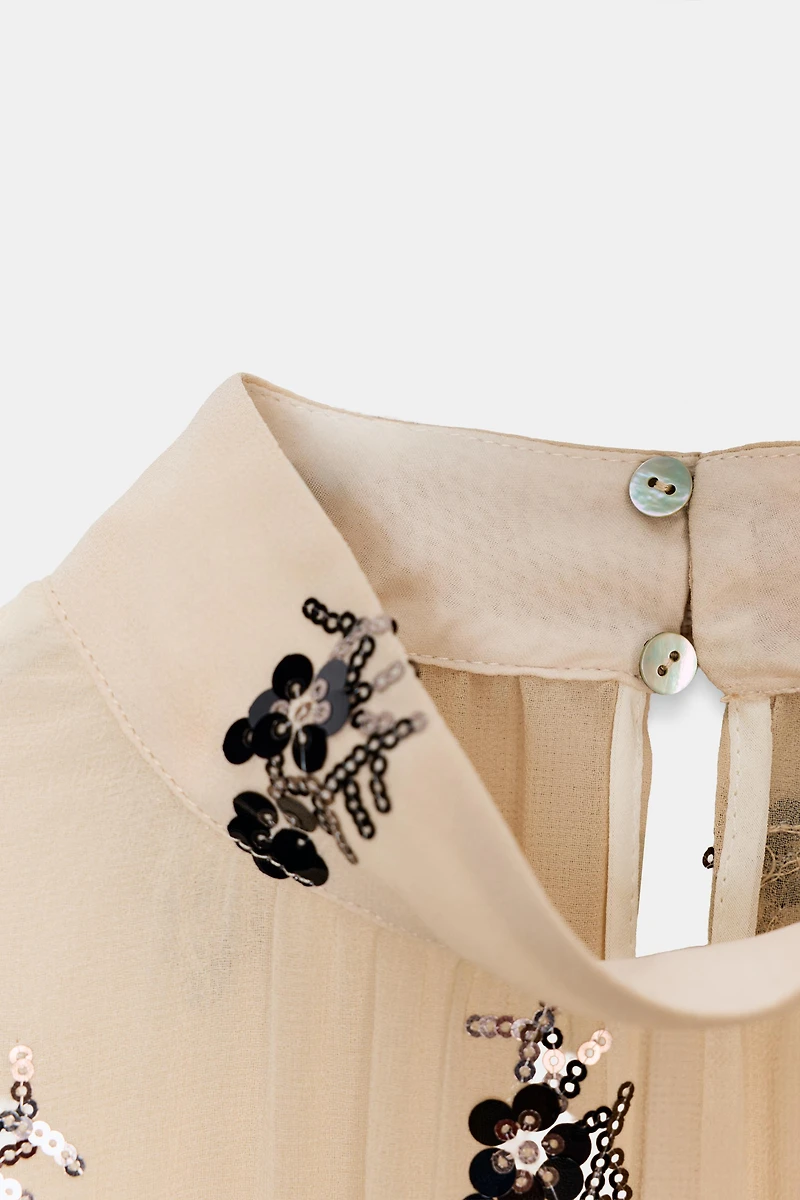 BLOUSE SEMI-TRANSPARENTE À PAILLETTES