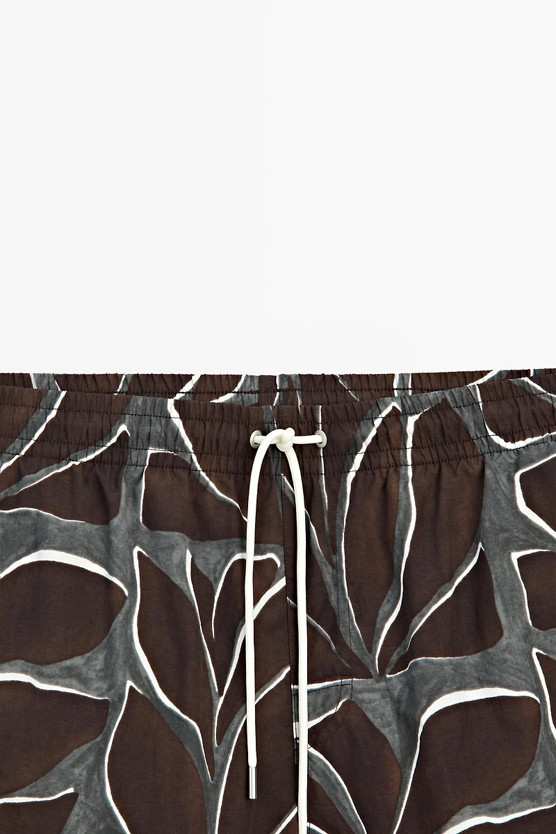 Tropical print swimming trunks