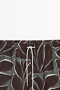 Tropical print swimming trunks