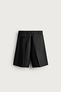 TEXTURED PLEATED SUIT SHORTS