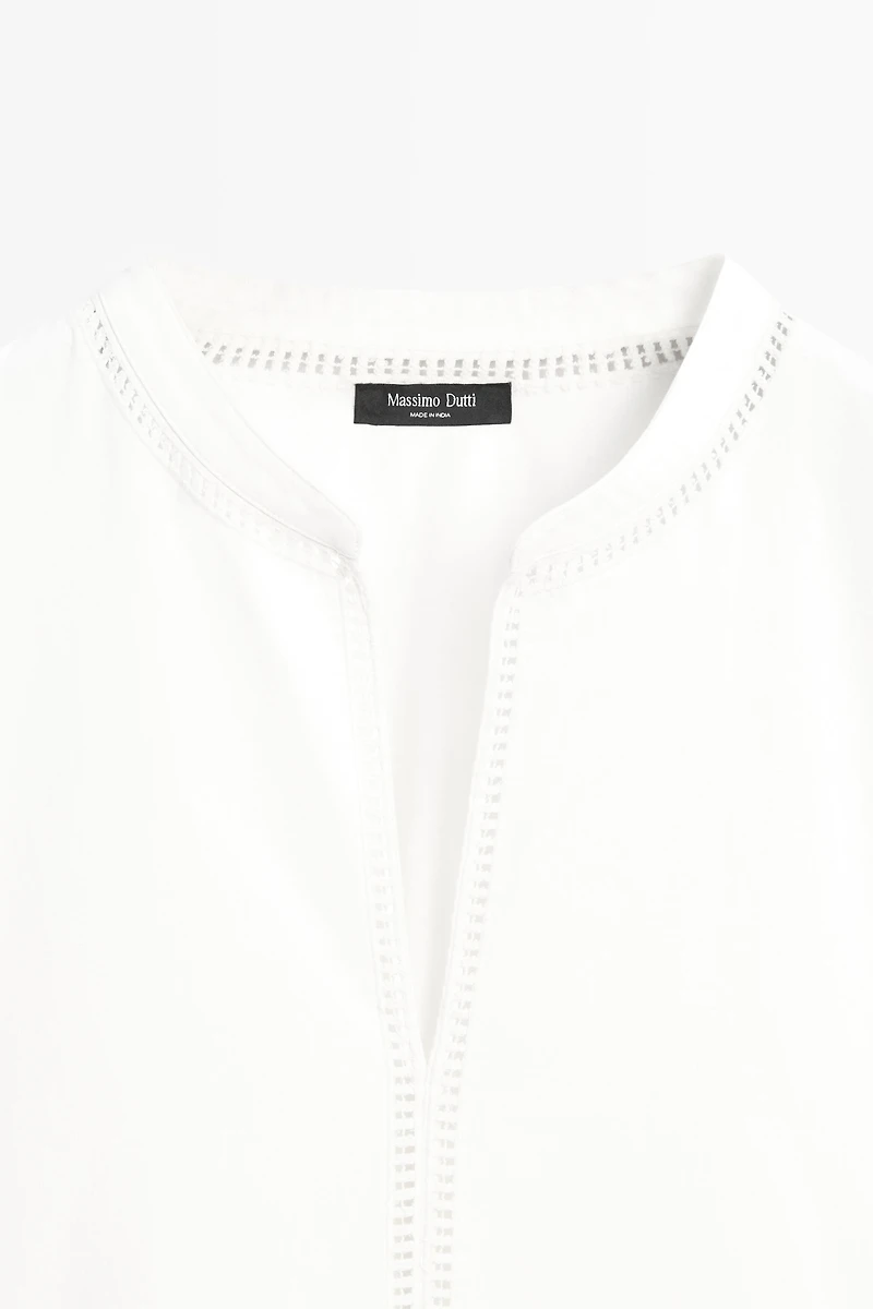 Embroidered blouse with fringed hem