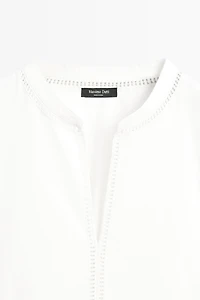 Embroidered blouse with fringed hem