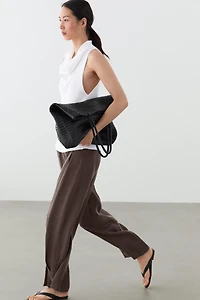 Total look flowing trousers with buttoned hems