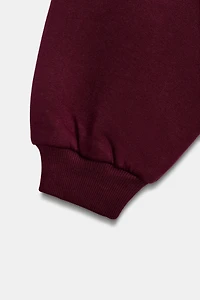 RUFFLED VARSITY SWEATSHIRT