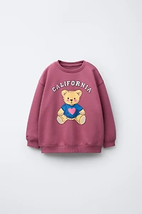 RAISED PRINT SWEATSHIRT