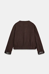 VESTE DOUCE AVEC FINITIONS EN MATIÈRE SYNTHÉTIQUE