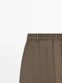 Flowing trousers with elasticated waistband