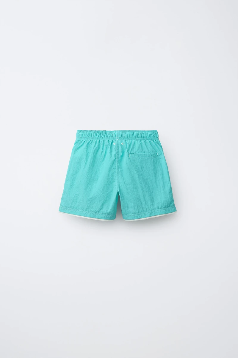 AGES 6-14 / SWIM SHORTS WITH DOUBLE CONTRAST HEM