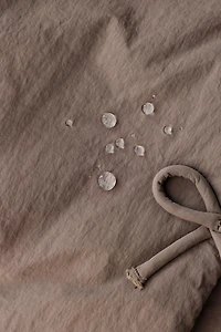WATER REPELLENT PUFFER COAT WITH BOWS