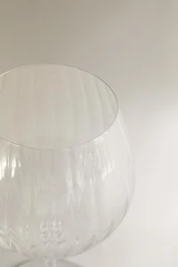 CRYSTALLINE GLASS WITH A RAISED DESIGN