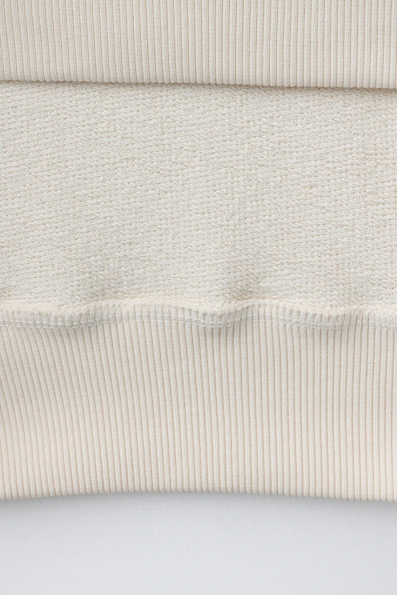 EMBROIDERED INSET SWEATSHIRT