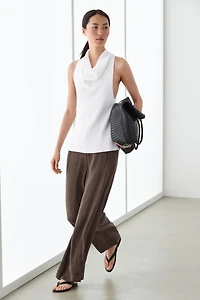 Total look flowing trousers with buttoned hems