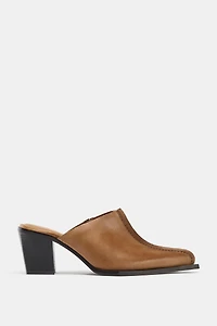 SABOTS EN CUIR AVEC SURPIQÛRE