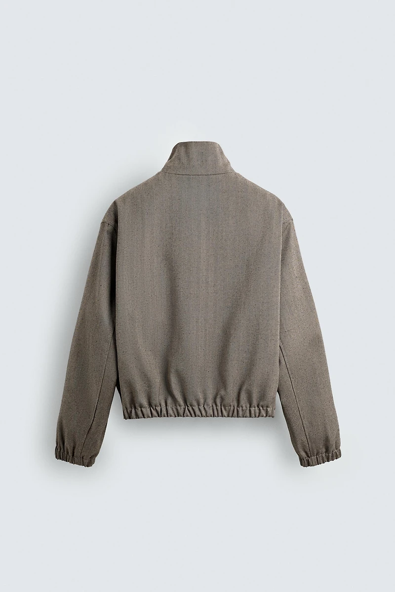 BLOUSON COURT COUPE STRUCTURÉE À CHEVRONS
