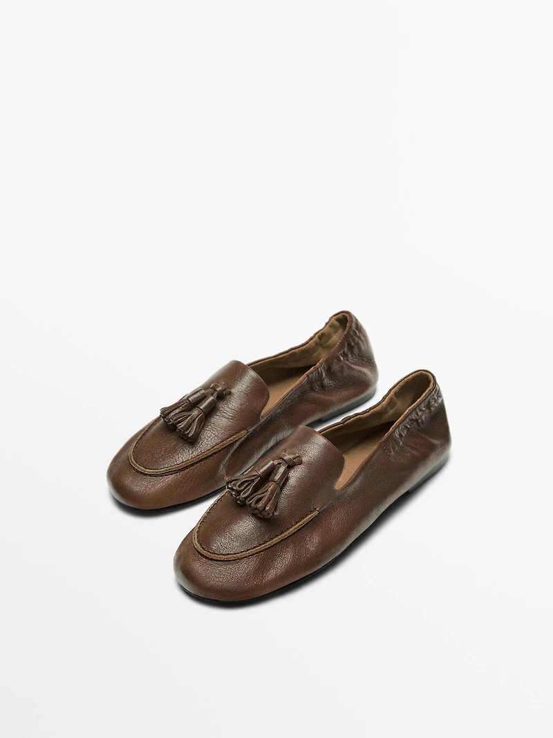 Mocassin en cuir à pompons