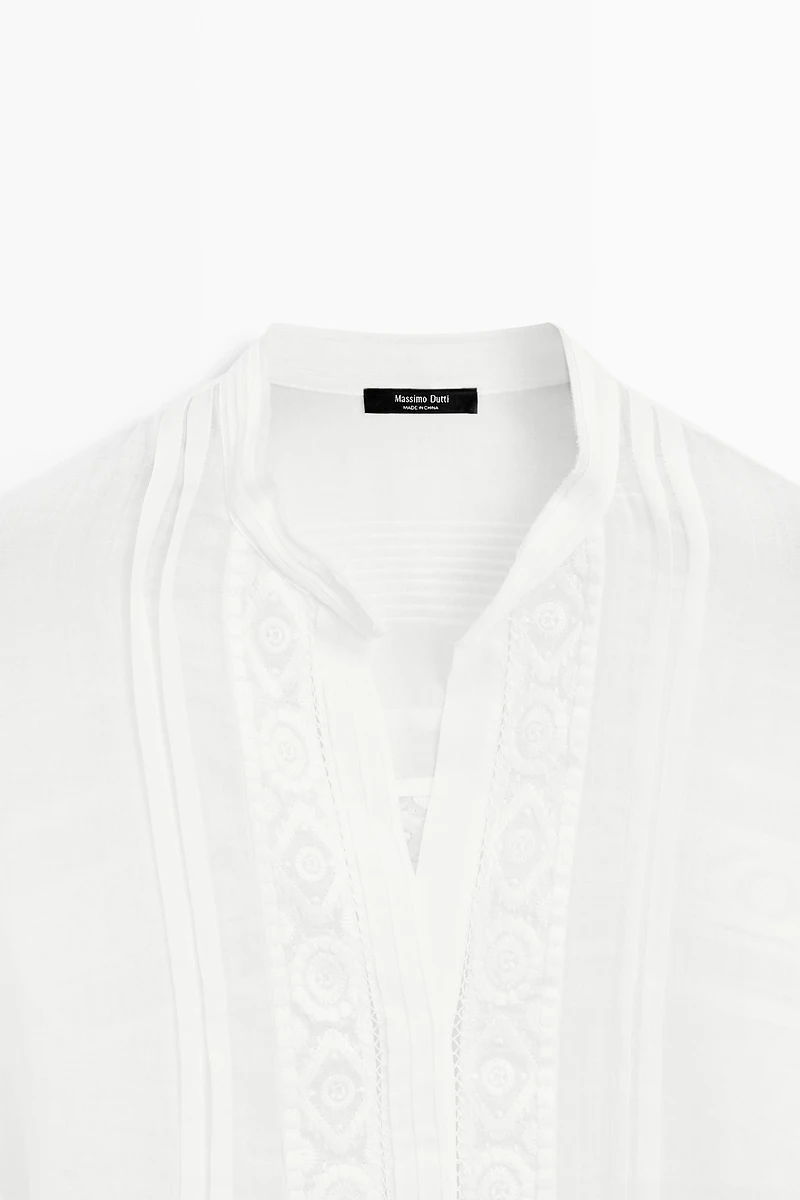 Stand collar blouse with embroidery and ruffles