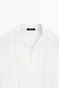 Stand collar blouse with embroidery and ruffles