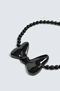 BOW NECKLACE HARRY LAMBERT FOR ZARA X DISNEY