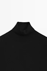 Asymmetric hem turtleneck top