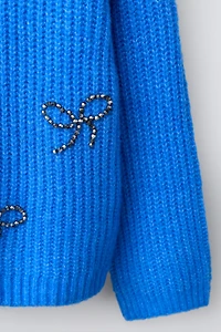 PULL EN MAILLE AVEC ORNEMENTS FANTAISIE LACETS BRILLANTS