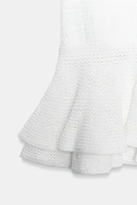 MINI JUPE EN MAILLE À VOLANTS