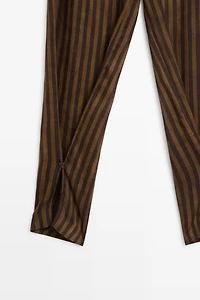 Total look flowing striped pants with button hem