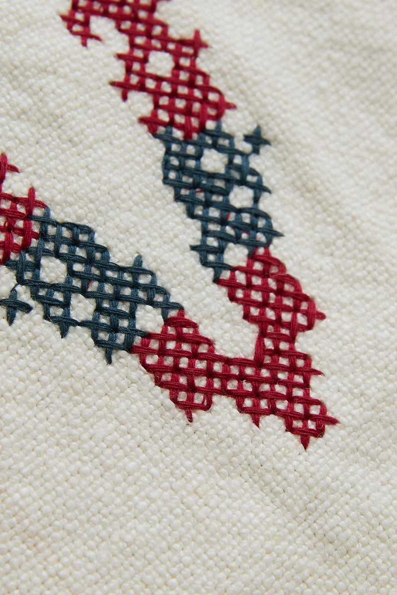 EMBROIDERED 'V' LETTER LINEN CUSHION