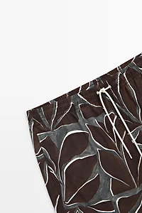 Tropical print swimming trunks